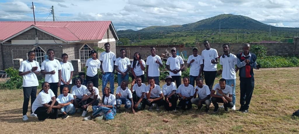 Union of Change youth community gathered outdoors in matching shirts